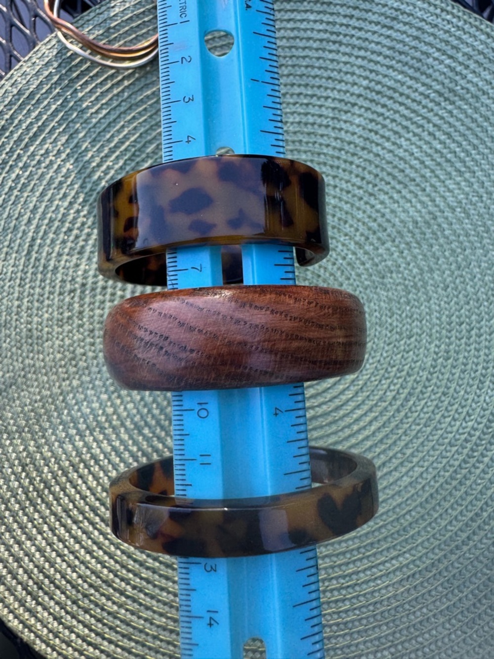 3 bracelets: 1 wood bangle, 2 faux tortoiseshell cuffs